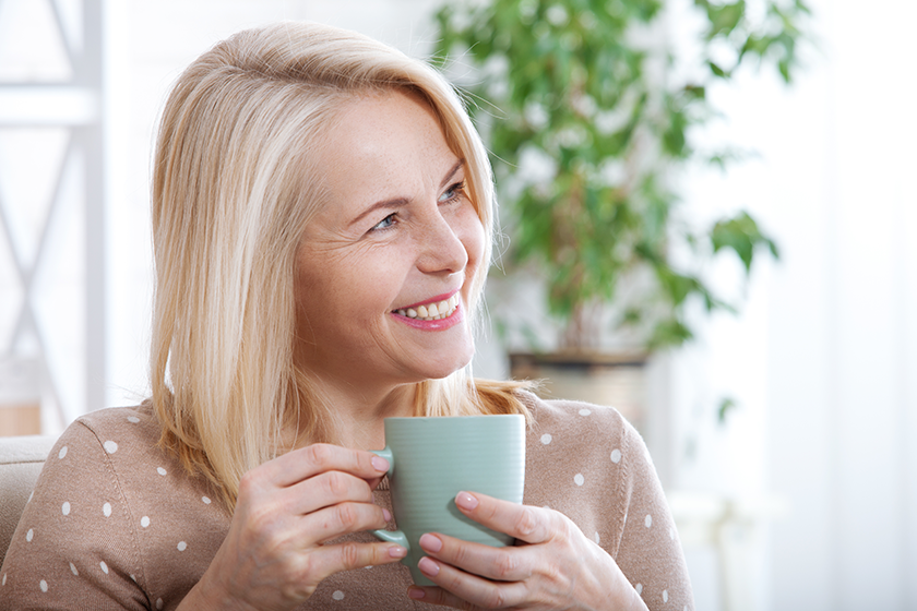 Portrait of happy blonde with mug in hands 