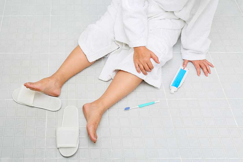 Woman falling in bathroom because slippery surfaces